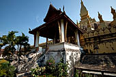 Vientiane, Laos - Surrounded by a cluster of pointed minor stupas the huge Pha That Luang shined under the warm light of the sunset. 